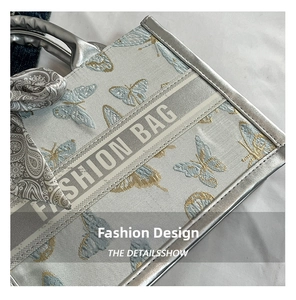 Close-up of exquisite butterfly embroidery and silk scarf handle on tote bag