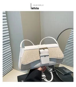 Detail of white leather handbag with faux-crocodile texture and square metal buckle