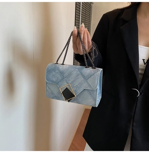 Detail of light blue gradient crossbody bag with denim texture and gold-black square buckle