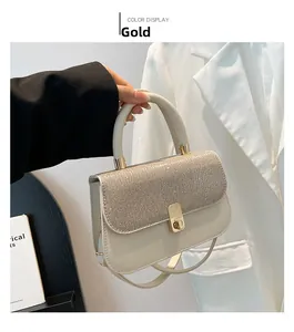 Detail of beige shoulder bag with gold sequined flap and metallic twist lock closure
