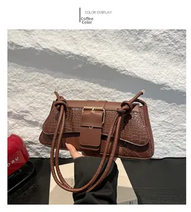 Detail shot of vintage coffee brown crocodile texture bag with metal buckle strap