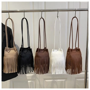 Détail des sacs seaux avec de longues franges et texture cuir en cinq coloris variés