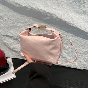 Minimalist light pink leather handbag with geometric texture and gold metal buckle