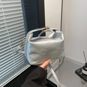 Silver square crossbody bag with quilted texture and gold lock for stylish women