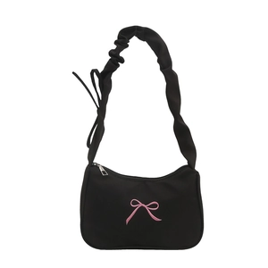 Minimalist black shoulder bag with pink bow embroidery and ruffled cloud strap design