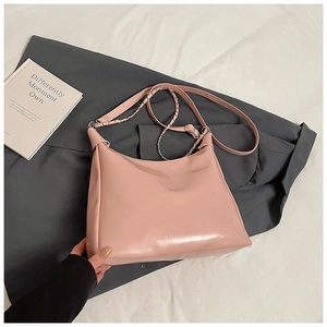 Pink PU leather hobo bag with adjustable strap and silver metal chain detail close-up