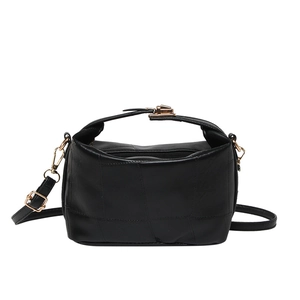 Fashionable black leather crossbody bag with unique patchwork and gold hardware clasp