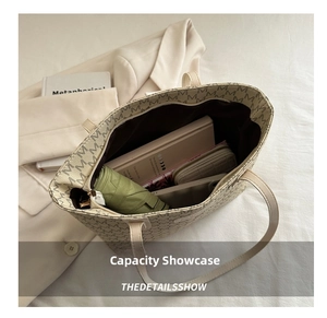 Top view of large capacity tote bag interior with umbrella, wallet and notebook inside