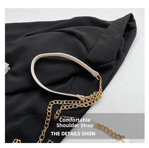 Detail of beige leather and gold chain strap with fine stitching and metallic finish