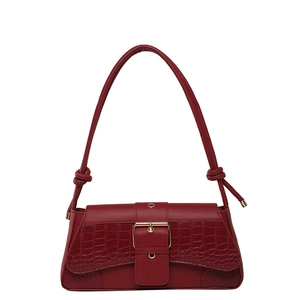 Deep red baguette shoulder bag with crocodile pattern and golden buckle on white background