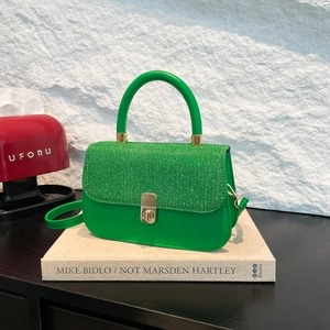 Green contrast textured small crossbody bag with gold twist lock on book