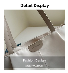 Close-up of canvas tote bag with brown straps and circular leather logo detail