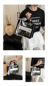 Detailed macro view of dark gold floral embroidery on the tote bag with decorative white ribbon