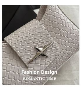 Close-up of beige woven leather bag detail with silver star-shaped metal buckle