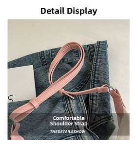 Close-up of light pink leather shoulder strap with fine stitching and silver metal buckle