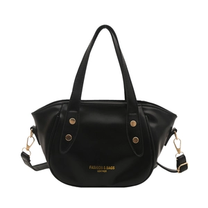 Minimalist black leather bucket bag with gold rivets and detachable shoulder strap