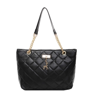 Black quilted tote bag with gold chain strap and deer pendant on white background
