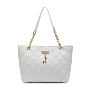 White quilted tote bag with gold chain strap and deer pendant on plain white background
