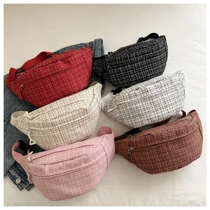 Multi-color collection of tweed crossbody waist bags in red, black, and beige tones