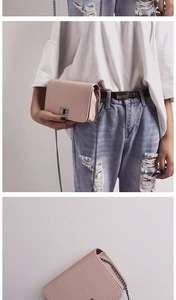 Detail view of pink PU leather small square bag with metal chain and vintage twist lock