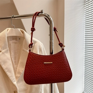 Elegant deep red crocodile pattern underarm bag with gold metal trim and knotted strap