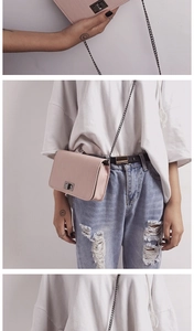 Detail of light pink crossbody bag with metal chain strap and turn-lock closure