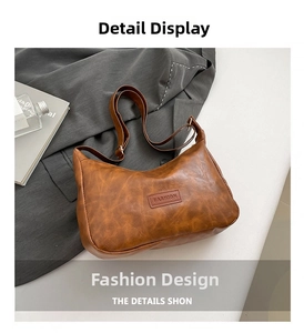 Detail of vintage brown faux leather shoulder bag with FASHION label and adjustable strap
