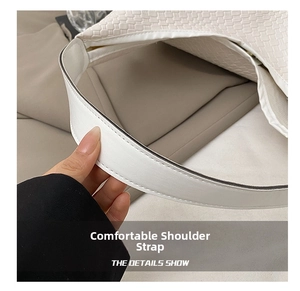 Close-up of comfortable leather shoulder strap and woven texture on white tote bag