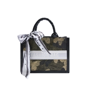 Elegant black tote bag with golden butterfly print and silk scarf accessory