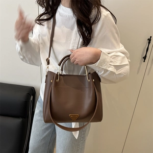 Brown retro tote bag with golden triangle plaque and cylindrical handles for women