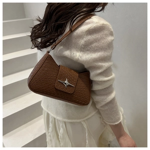 Brown faux crocodile leather underarm bag with a silver star buckle on a shoulder strap