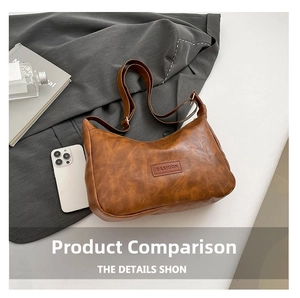 Detail view of brown vintage pillow bag with FASHION embossed logo on a lifestyle background