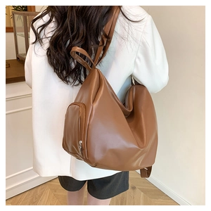 Detailed back view of a large caramel leather backpack for women with side pocket