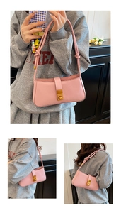 Detailed close-up of a pink matte leather shoulder bag with golden buckle and knotted strap