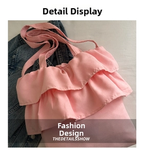 Detail of pink ruffled canvas tote bag showing tiered pleats and wide shoulder strap