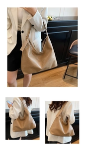 Detail of khaki hobo bag showing woven texture and fashion tag on shoulder strap