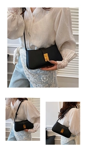 Detail view of matte black shoulder bag featuring a vintage gold rectangular buckle
