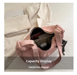 Top view of pink suede tote bag showing spacious interior with metal zipper and strap
