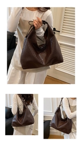 Detailed view of large dark brown hobo tote with crocodile embossed texture and soft structure
