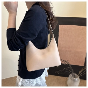 Chic beige hobo bag detail featuring smooth texture and adjustable slim shoulder strap