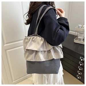 Detail of ruffled dual-layer edge and contrast stitching on a large canvas tote bag