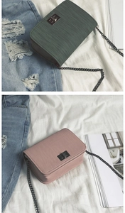Detail view of small chain bags with textured finish and elegant metal twist locks