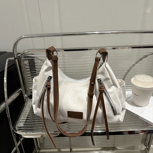 Large capacity white tote bag with brown straps and side zippers for daily commute