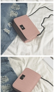 Detail of pink crossbody bag with horizontal texture and black metallic twist lock closure