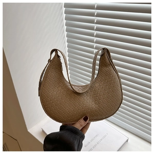 Close-up of khaki woven crescent hobo bag featuring premium intrecciato texture