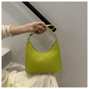 Close-up of grass green crescent underarm bag with silver buckle and matte leather texture