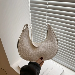 Minimalist beige woven crescent underarm bag with zipper and adjustable strap