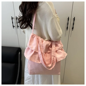 Detailed back view of pink ruffled tote bag with layered pleats and nylon fabric