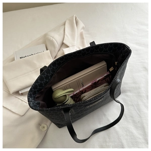 Top view of large black tote bag showing spacious interior with books and organizer pocket