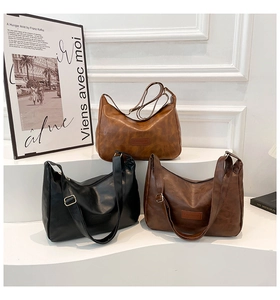 Three retro faux leather hobo bags in black, light brown, and dark brown colors